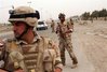 Iraqi soldiers from the 6th Iraqi Army Division stand guard on a 
road in Baghdad April 5, 2008. (Stringer/Reuters)