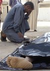 A man grieves near the body of a relative who was killed in a bomb
 attack, in a hospital morgue in Baquba, 65 km (40 miles) northeast of 
Baghdad April 6, 2008. One person was killed while others were wounded 
in a roadside bomb attack in Baquba on Sunday, police said. 
(Stringer/Reuters)