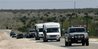 Officials escort two buses Friday April 4, 2008 from the retreat 
built by the Fundamentalist Church of Jesus Christ of Latter Day Saints,
 located near El Dorado, Texas. Child welfare officials and state 
troopers removed at least one busload of children from the secretive 
West Texas religious retreat built by polygamist leader Warren Jeffs 
following a complaint to state authorities.  (AP Photo/Harry Cabluck)