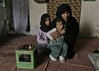 Badriya Hameed,  a 45-year-old Shiite Kurdish cleaning woman sits 
with two of her 10 children, eleven years old  Ramlah Fadhil and two 
year old  Roa'a Fadhil, at her home in Baghdad, Iraq, Wednesday, 
February 27, 2008. Badriya was forced to flee her predominantly Sunni 
neighborhood after her husband was killed on May 23, 2007. (AP 
Photo/Karim Kadim)