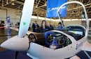 Boeing employees pose by a plane which 
is powered by a hydrogen battery at their research centre in Ocana, 
Spain.(AFP/Philippe Desmazes)