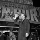 US actor Charlton Heston poses in front of the 
poster of the film "Ben Hur" directed by William Wyler, in 
Paris, 1960. Heston, the chisel-jawed Hollywood icon best remembered for
 his Oscar-winning performance in "Ben Hur" has died at his 
home, his family said. He was 84.(AFP/File)